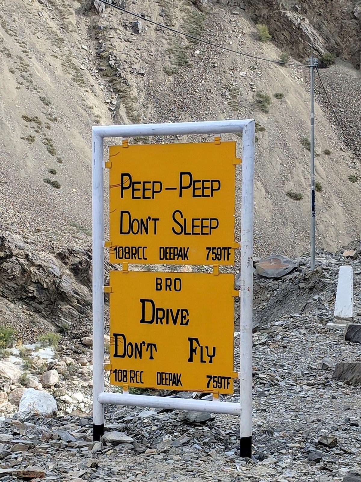 A roadside sign with Peep Peep Don't Sleep, Drive Don't Fly